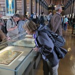 Dawn looking at a reproduction of a page from The Book of Kells