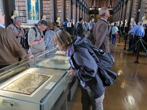 Dawn looking at a reproduction of a page from The Book of Kells