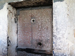 Close up of a cell door, showing the peep holes