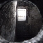 Looking through a peep hole into a cell in the old wing